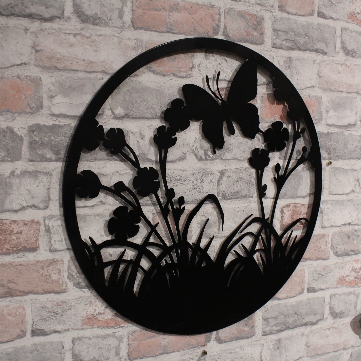 Silhouette de papillon volant rond en métal